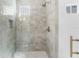 Bright shower with gray tiled walls, a gold shower head, and a small window at 5337 6Th N Ave, St Petersburg, FL 33710
