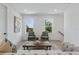 Cozy sitting area features two chairs, a wooden coffee table, and bright natural light at 5337 6Th N Ave, St Petersburg, FL 33710