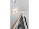 Staircase with wooden handrail and black metal spindles leading to the second floor of the home at 5337 6Th N Ave, St Petersburg, FL 33710