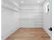 Bright walk-in closet with wooden floor and white walls, offering ample storage space with shelving at 5337 6Th N Ave, St Petersburg, FL 33710
