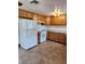 Functional kitchen features wooden cabinets, tile flooring, and essential appliances at 6013 Maple Ln, Tampa, FL 33610