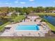 Aerial view of a home with a swimming pool surrounded by water at 7440 Mint Julep Dr, Riverview, FL 33578