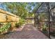 Charming backyard stone paver walkway leading to a screened lanai at 7440 Mint Julep Dr, Riverview, FL 33578