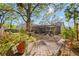 Spacious backyard with lush landscaping, brick paver patio, and screened enclosure at 7440 Mint Julep Dr, Riverview, FL 33578