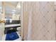 Bathroom featuring a bathtub with black and white tile, a shower with curtain, and a blue rug at 7440 Mint Julep Dr, Riverview, FL 33578