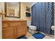 Cozy bathroom with a single sink vanity, toilet, and shower tub featuring a polka dot shower curtain at 7440 Mint Julep Dr, Riverview, FL 33578