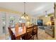 Charming dining room showcasing an elegant chandelier and access to the outdoors at 7440 Mint Julep Dr, Riverview, FL 33578