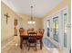 Bright dining area features a classic chandelier and access to outdoor patio at 7440 Mint Julep Dr, Riverview, FL 33578