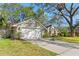 Beautiful home with a well-kept lawn, complemented by mature trees and a two-car garage at 7440 Mint Julep Dr, Riverview, FL 33578