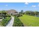 Beautiful home exterior with well-manicured landscaping and lake views at 7440 Mint Julep Dr, Riverview, FL 33578