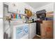 Bright laundry area with a washing machine, dryer, shelving, and storage space at 7440 Mint Julep Dr, Riverview, FL 33578