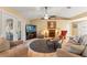 Cozy living room featuring a fireplace, ceiling fan, and access to the outdoors at 7440 Mint Julep Dr, Riverview, FL 33578