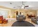 Comfortable living room with a ceiling fan, tiled floors, and ample seating at 7440 Mint Julep Dr, Riverview, FL 33578