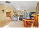 Inviting living room with tile flooring, ceiling fan, and access to both the dining area and outdoor patio at 7440 Mint Julep Dr, Riverview, FL 33578