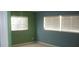 A bedroom with neutral toned walls and white blinds covering the bright windows at 780 116Th Ave, Treasure Island, FL 33706