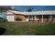 Charming brick home featuring a well-manicured lawn, attached garage and classic architectural details at 780 116Th Ave, Treasure Island, FL 33706
