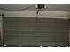 Inside the garage with closed metal overhead door and garage door opener at 780 116Th Ave, Treasure Island, FL 33706