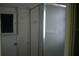 Small shower enclosure with glass door, tiled walls, and silver trim at 780 116Th Ave, Treasure Island, FL 33706
