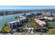 Wide aerial perspective of a coastal condominium community with water views and lush landscaping at 7963 Sailboat Key Blvd # 601, St Pete Beach, FL 33707