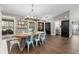 Bright dining room with wood floors, rustic table, and modern lighting fixtures, great for gatherings at 1013 Newberger Rd, Lutz, FL 33549