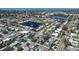 Birds eye view of a cozy neighborhood with houses surrounding a beautiful lake, enhancing community charm at 10915 Hammock Dr, Largo, FL 33774
