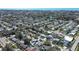 Overhead view showcasing a residential area with diverse homes, lush landscaping, and a scenic lake in the background at 10915 Hammock Dr, Largo, FL 33774