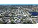 An aerial view displays a well-planned residential neighborhood with houses, streets, and a serene lake at 10915 Hammock Dr, Largo, FL 33774