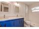 Bathroom with double sinks, modern lights, and a sleek toilet at 10915 Hammock Dr, Largo, FL 33774