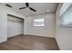 Clean bedroom with wood-look flooring and closet at 10915 Hammock Dr, Largo, FL 33774
