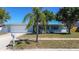 Charming single-story home featuring a well-manicured lawn and beautiful landscaping at 10915 Hammock Dr, Largo, FL 33774