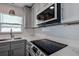 Updated kitchen featuring stainless steel appliances, white countertops, and white cabinets at 10915 Hammock Dr, Largo, FL 33774