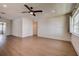 Bright living room featuring wood-look flooring, ceiling fan, and neutral paint colors at 10915 Hammock Dr, Largo, FL 33774