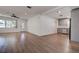 Open-concept living room with wood-look floors that flow to the kitchen and entryway at 10915 Hammock Dr, Largo, FL 33774
