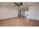 Spacious living room showcasing modern wood-look floors and a ceiling fan fixture at 10915 Hammock Dr, Largo, FL 33774