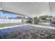 Covered patio features brick pavers and a backyard with a white privacy fence at 10915 Hammock Dr, Largo, FL 33774