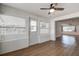 Bright sunroom with multiple windows, white brick accents, and a door leading to the outdoors at 10915 Hammock Dr, Largo, FL 33774