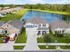 Aerial view of a well-maintained home with a pond view and manicured landscaping in a residential neighborhood at 11617 Miracle Mile Dr, Riverview, FL 33578