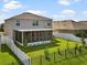 A backyard view of the home featuring a screened patio and combination of fences at 11617 Miracle Mile Dr, Riverview, FL 33578