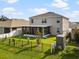 View of the home's backyard and screened in patio, as well as the combination of fence types at 11617 Miracle Mile Dr, Riverview, FL 33578