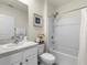Bathroom featuring a shower-tub combo, a white vanity with a sink, and coastal-themed decor accents at 11617 Miracle Mile Dr, Riverview, FL 33578