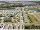 Aerial view of a vibrant community featuring a pool and playground, surrounded by picturesque ponds at 11617 Miracle Mile Dr, Riverview, FL 33578
