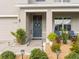 Inviting front porch with seating, a 'Welcome' sign, and lovely landscaping, creating a warm entrance at 11617 Miracle Mile Dr, Riverview, FL 33578