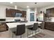 Contemporary kitchen featuring a spacious island with bar stools, stainless steel appliances, and sleek cabinetry at 11617 Miracle Mile Dr, Riverview, FL 33578