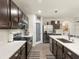 Modern kitchen featuring stainless steel appliances, white countertops, and dark wood cabinetry at 11617 Miracle Mile Dr, Riverview, FL 33578