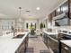 Bright, open kitchen with an island and modern appliances, flowing into the dining area at 11617 Miracle Mile Dr, Riverview, FL 33578