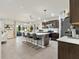 Open kitchen featuring a large island with seating, modern appliances, and seamless flow to the living area at 11617 Miracle Mile Dr, Riverview, FL 33578
