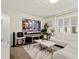 Comfortable living area with a white sofa, large TV, and plenty of natural light at 11617 Miracle Mile Dr, Riverview, FL 33578
