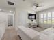 Upstairs living room featuring a white sofa, large window with shutters, and a ceiling fan at 11617 Miracle Mile Dr, Riverview, FL 33578