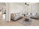 Elegant living room featuring modern sofas, neutral decor, and a stylish rug, creating a comfortable space at 11617 Miracle Mile Dr, Riverview, FL 33578