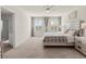 Bright main bedroom with neutral tones, a king-size bed, and ample natural light from large windows at 11617 Miracle Mile Dr, Riverview, FL 33578